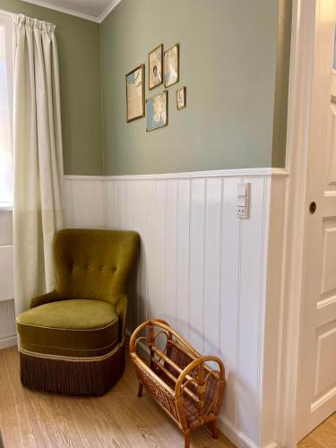 a chair and a ottoman in a room at Hotel Klostergaarden in Allinge