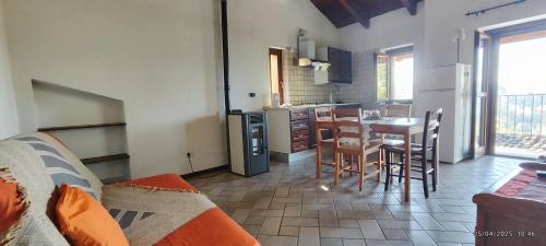 a kitchen with a table and chairs in a room at Cà Borgo Vecchio in Brusasco