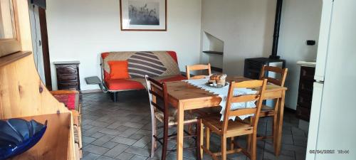 a dining room with a wooden table and chairs at Cà Borgo Vecchio in Brusasco