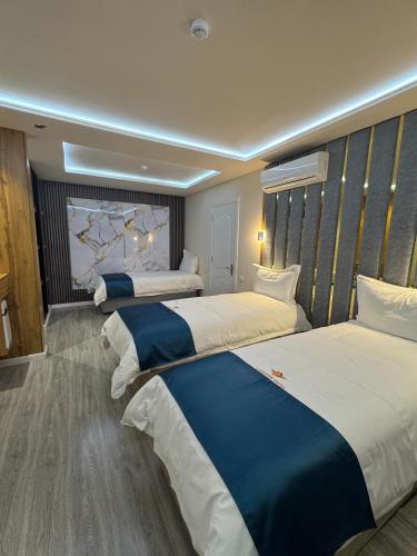 a hotel room with three beds in a room at LakeSide Hotel by EDEN Group in Tashkent