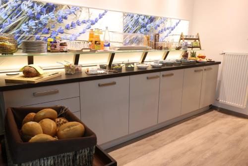 a kitchen with a counter with a bowl of bread at Landhaus Beth-Steuer in Valwig