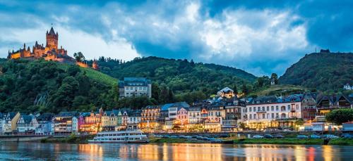 a town on the river with a castle in the background at Landhaus Beth-Steuer in Valwig