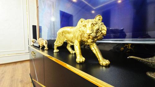 a gold lion statue sitting on top of a shelf at Sultan hotel boutique in Andizhan