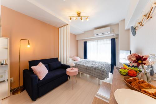 a living room with a couch and a table at Felizstay Tokyo in Tokyo