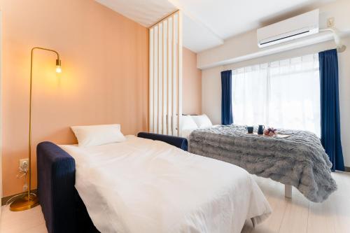 a hotel room with a bed and a window at Felizstay Tokyo in Tokyo