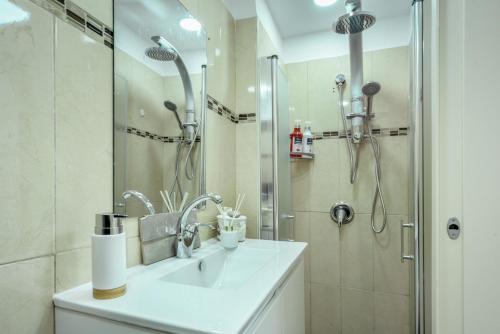 a bathroom with a sink and a shower at Havatselet 19 By Isrentals in Jerusalem