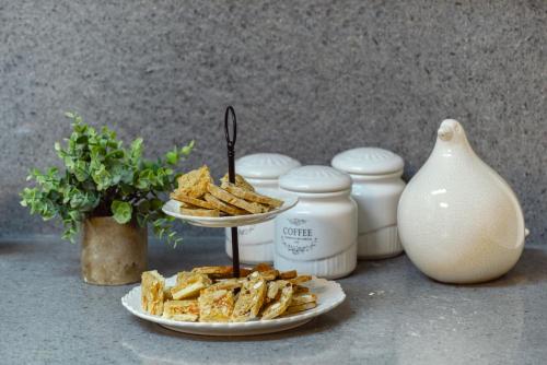 a plate of crackers and a plate of chips at Havatselet 19 By Isrentals in Jerusalem
