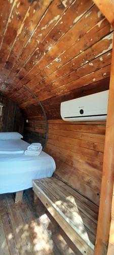 a room with two beds in a wooden cabin at Garden Villa Lake Side & Glamping in Ksamil