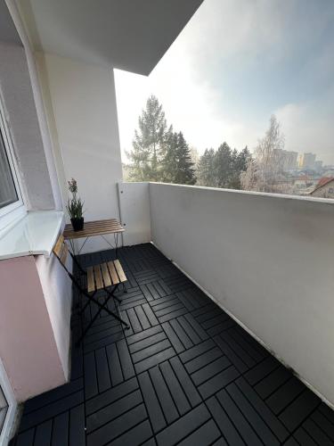 an empty balcony with a bench and a window at Apartmán MEDIK in Martin