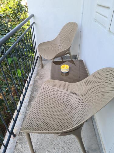two chairs sitting on a balcony with a candle at Casa-Cristiano in Sutomore
