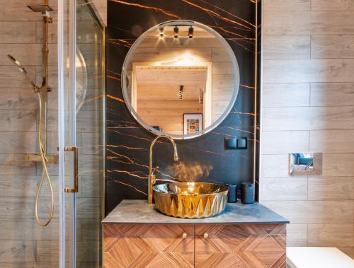 a bathroom with a copper sink and a mirror at Brdy Koniakowskie in Koniaków