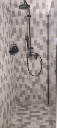 a shower with a shower head in a bathroom at Unwind and Relax in Amanzimtoti