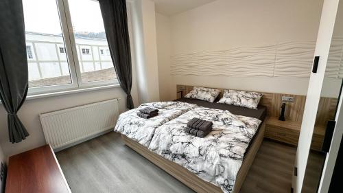 a bedroom with a bed with two bags on it at Villa Leopold - apartmánový dům in Karlovy Vary