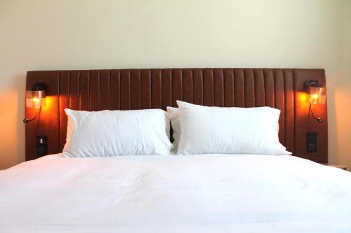 a large bed with white sheets and pillows at Adonis le Castellet in Signes