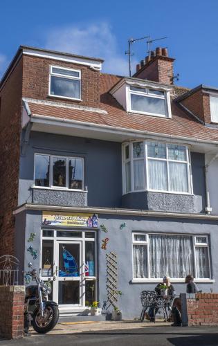 a building with a motorcycle parked in front of it at Home and Away near the Spa in Bridlington