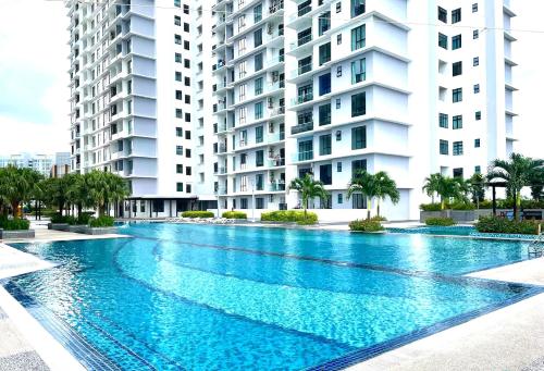 a swimming pool in front of two tall buildings at The Platino Skudai Johor Bahru in Johor Bahru