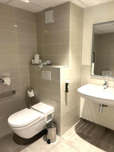 a bathroom with a toilet and a sink at Adonis le Castellet in Signes