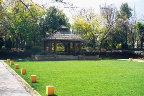 a gazebo in a park with green grass at InterContinental Kunming by IHG in Kunming