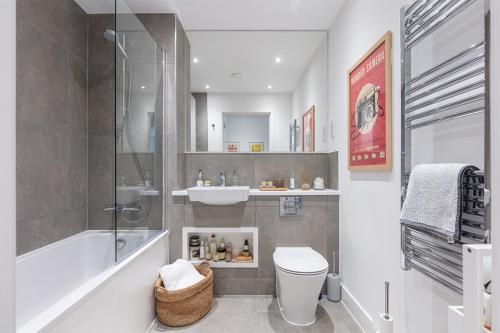 a bathroom with a shower and a toilet and a sink at Modern 2BD Apt w/ Balcony & Parking - Near London in Shephall