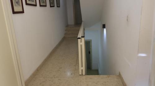 a hallway with a stairway leading up to a room at Candid Aura Studio Chic Sliema Basement Apartment in Il-Gżira taʼ Forti Manoel
