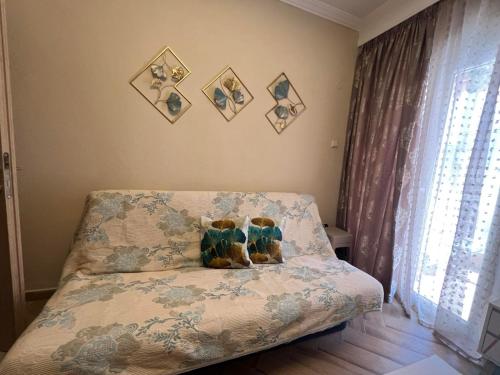 two teddy bears sitting on a bed in a bedroom at Blue Horizon Seaside Studio in Nea Kalikratia