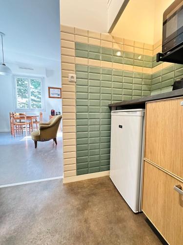 Il comprend une cuisine équipée d'un réfrigérateur et une salle à manger. dans l'établissement Appartement à 300m de la plage, à La Tremblade