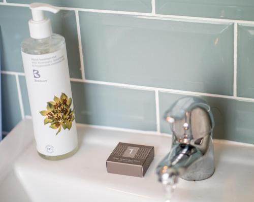 a bathroom sink with a bottle of mouthwash and a soap at The Crown in Poole