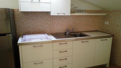 a kitchen with a sink and a counter top at Appartamento Villa Elison in Lazise
