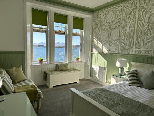 a bedroom with a bed and two windows at Royal Bank Flat in Oban