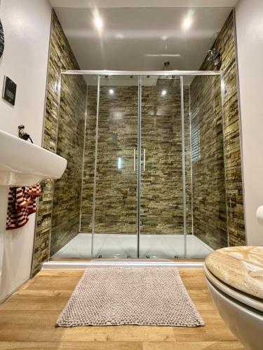 a shower with a glass door in a bathroom at Acorn Lodge Pentewan in St Austell