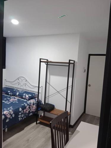 a bedroom with a bed and a chair in it at Homestay Daud in Bandar Permas