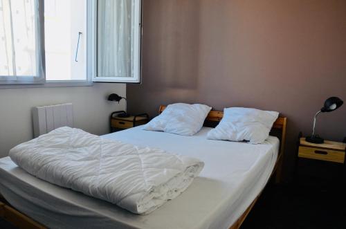 En eller flere senge i et værelse på à quelques pas de la plage