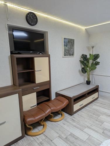 un soggiorno con TV a schermo piatto e sgabello di Wohnung "Anna" a Stadtallendorf