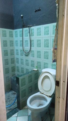 a bathroom with a toilet and a shower at Kranggan Bethlehem Homestay in Yogyakarta