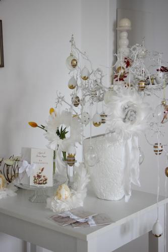 a table with a vase filled with white flowers at Villa Loreta in Ischia
