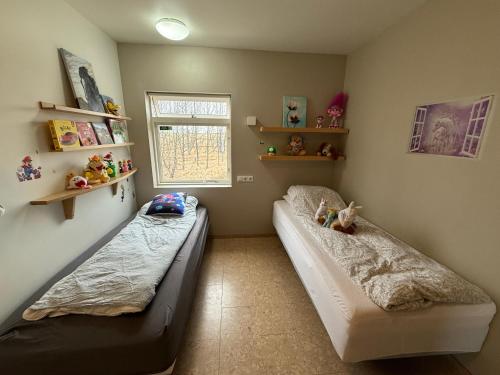 a bedroom with two beds and a window at Beautiful family home in South-Iceland perfect for groups and families in Hella
