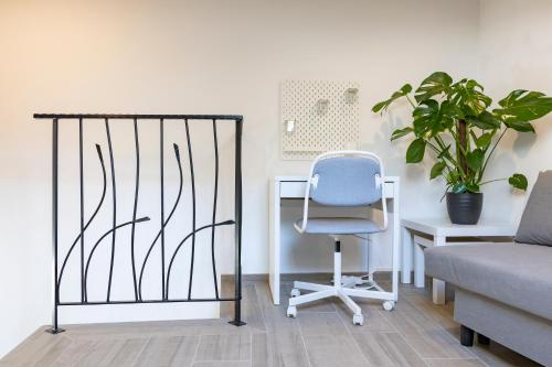 a room with a chair and a desk and a plant at Torre delle Rondini in Isolabona