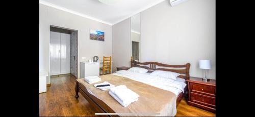 a bedroom with a large bed with towels on it at Embrace in Truskavets