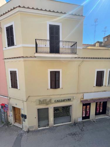 a building with a balcony on top of it at A due passi dal mare 2023 in Nettuno