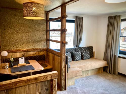 a living room with a couch and a table at Schittlerhof in Fischen