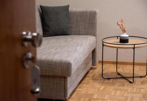 a living room with a chair and a table at Gasthaus Jägerhaus in Fridingen an der Donau