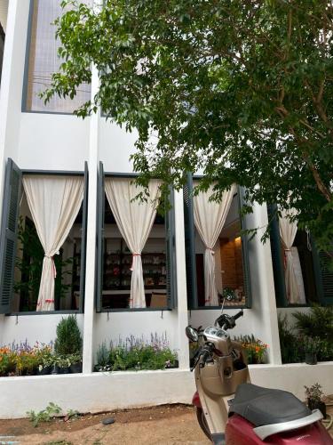 a scooter parked in front of a building at Ena Boutique Hotel & Cafe in Chiang Mai