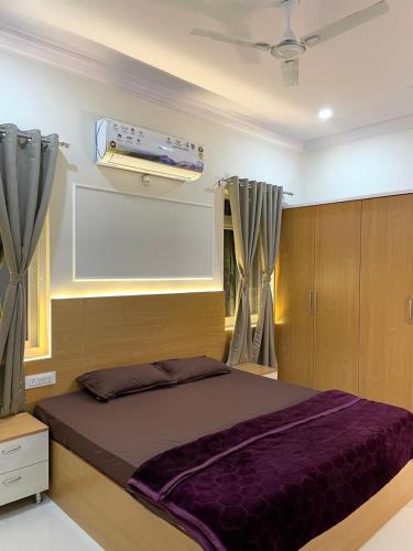 a bedroom with a large bed with a ceiling at Luxury Homes in Hyderabad