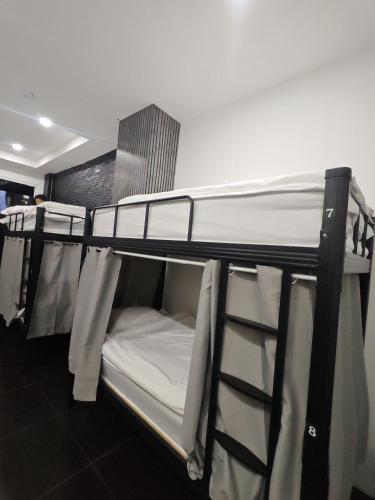 a couple of bunk beds in a room at TJ PATONG HOSTEL - Prime Location by OTOP Market & Sea in Patong Beach