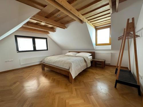 a bedroom with a bed and a wooden floor at Kralova Apartment in Modra in Modra