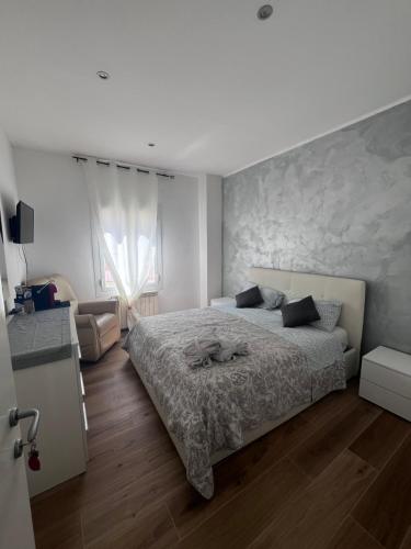 a bedroom with a large bed and a couch at La Casa del Giglio in Albenga