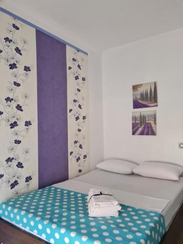 a bed with a blue and white polka dot mattress at SeaViewPeramou in Elevtheraí