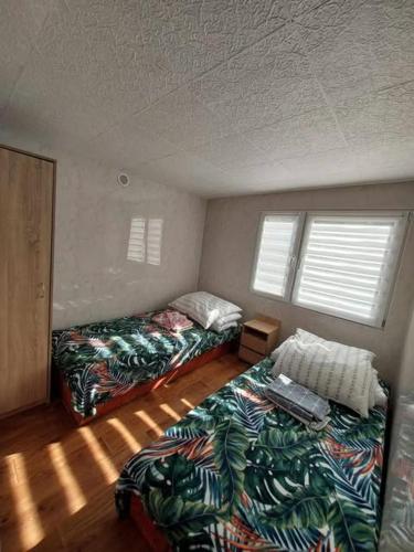 a room with two beds and a couch and windows at Domek letniskowy ,,Jolczyn'' in Nowęcin