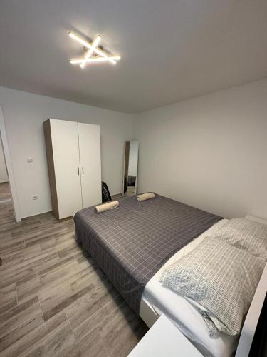 a bedroom with a bed and a ceiling fan at Mimis Apartments in Novalja