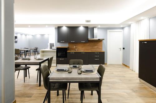 a kitchen and dining room with tables and chairs at Villa Olivieri B&B Wellness House in Viterbo